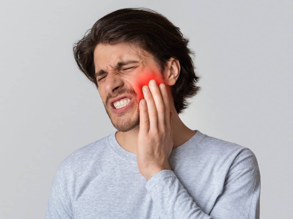 Severe pain in the jaw, bad breath, and gum inflammation are impacted wisdom teeth symptoms