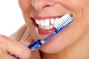 Flossing around the dental implants is important to ensure proper cleaning, as well as using an interdental brush or water flosser to help remove plaque and debris buildup between teeth.