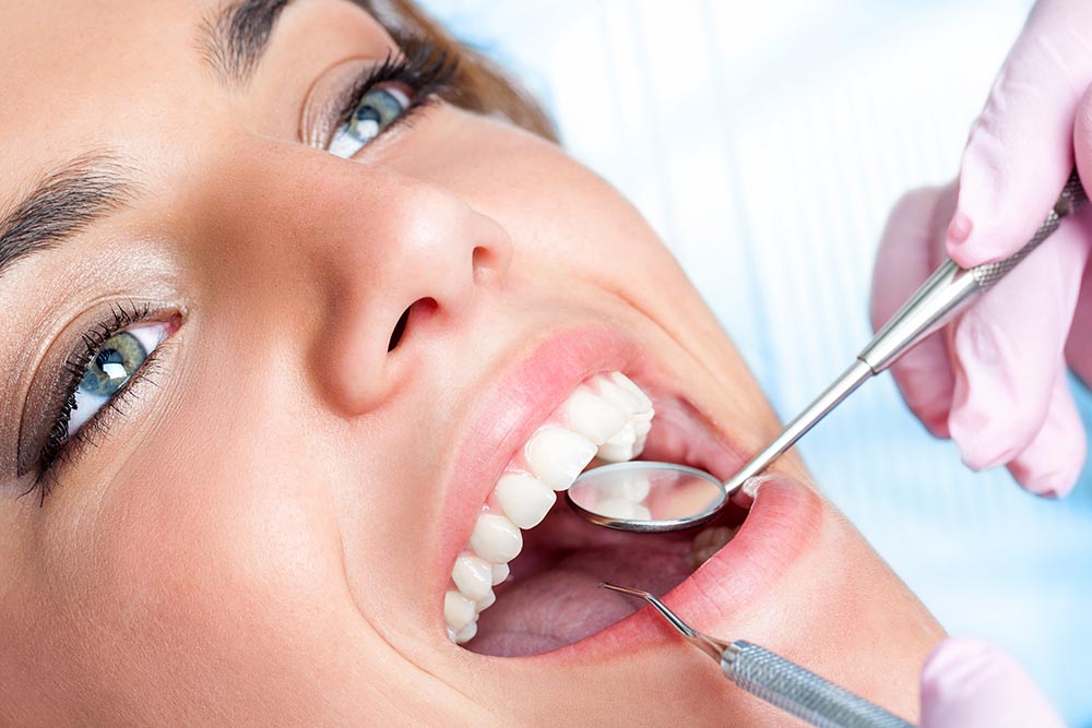 Young woman open her mouth during a dental checkup