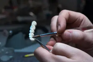 Expert dentist preparing for a Dental bridge procedure in his dental practice.