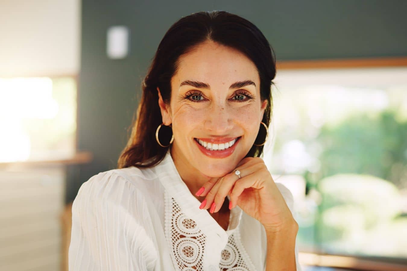 Smiling woman during dental implant consultation, representing planning after bone graft for implant placement.